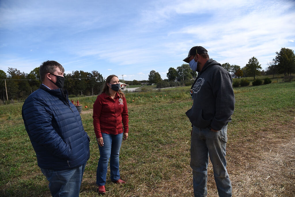 Rep. Sara Walsh and her husband, Steve Walsh, talk to Zach Diederich who drives the wagons at Lloyd's Family Farm on Friday in Ashland, Mo.